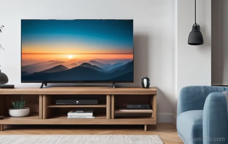 주자동 케이블연결확인 - A person in their 30s, wearing clean, practical clothes, is kneeling behind a home entertainment set...