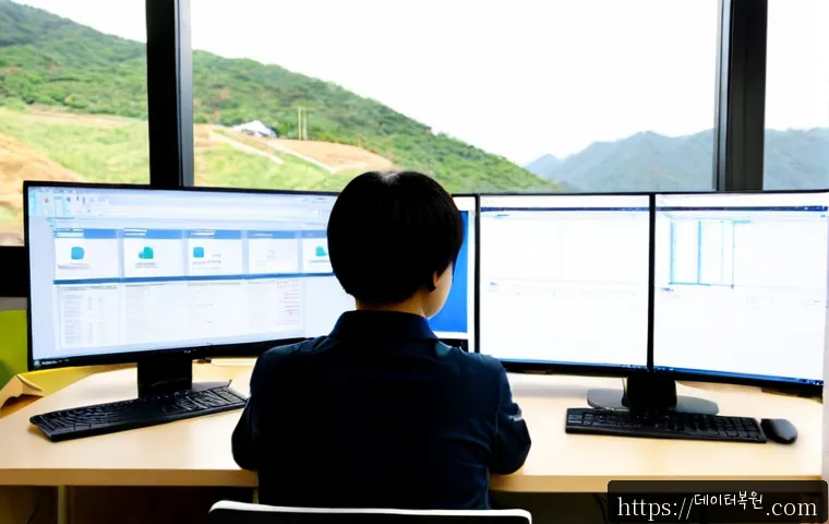 불광동 UDFS_FILE_SYSTEM - Photorealistic IT workstation in a compact Bulgwang-dong apartment office, dual monitors showing abs...